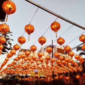 Chinese lantern illuminate an overhead structure, celebrating the Lunar New Year